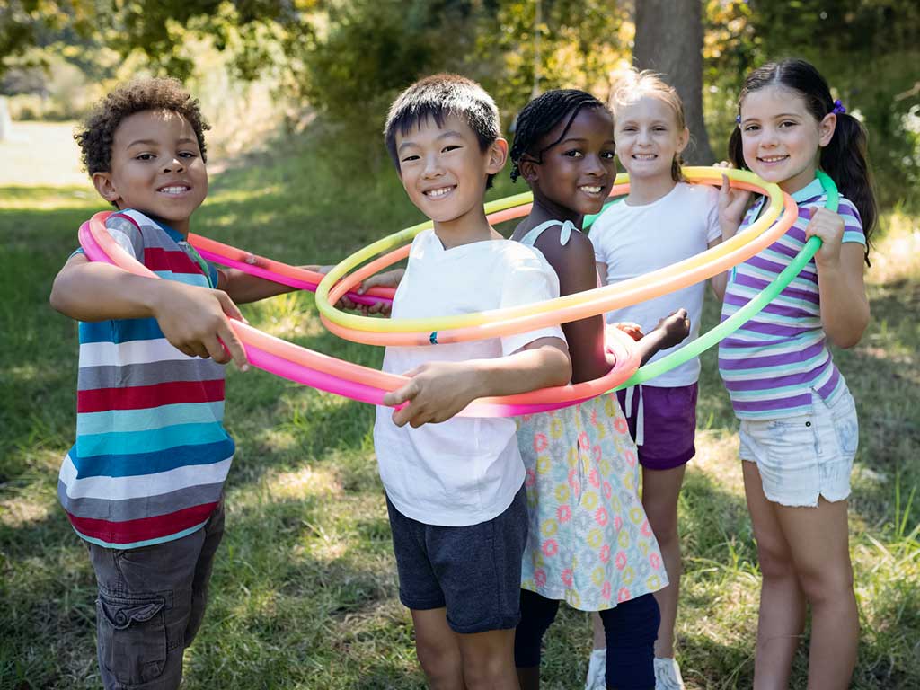 A group of young kids with hoops.