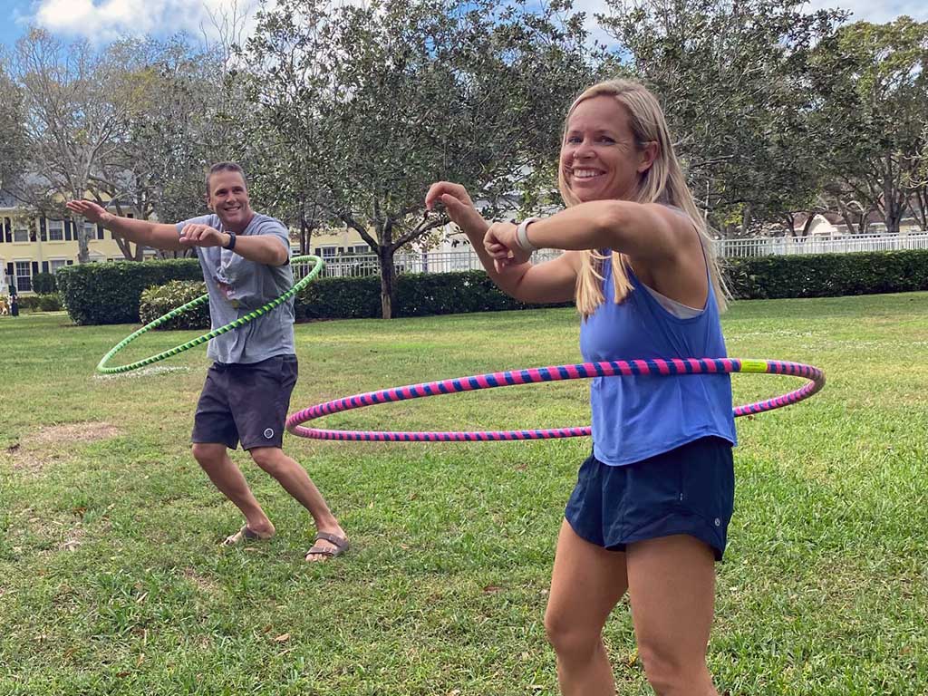 Legit parents having fun hula hooping. Two legit parents having fun with hula hoops